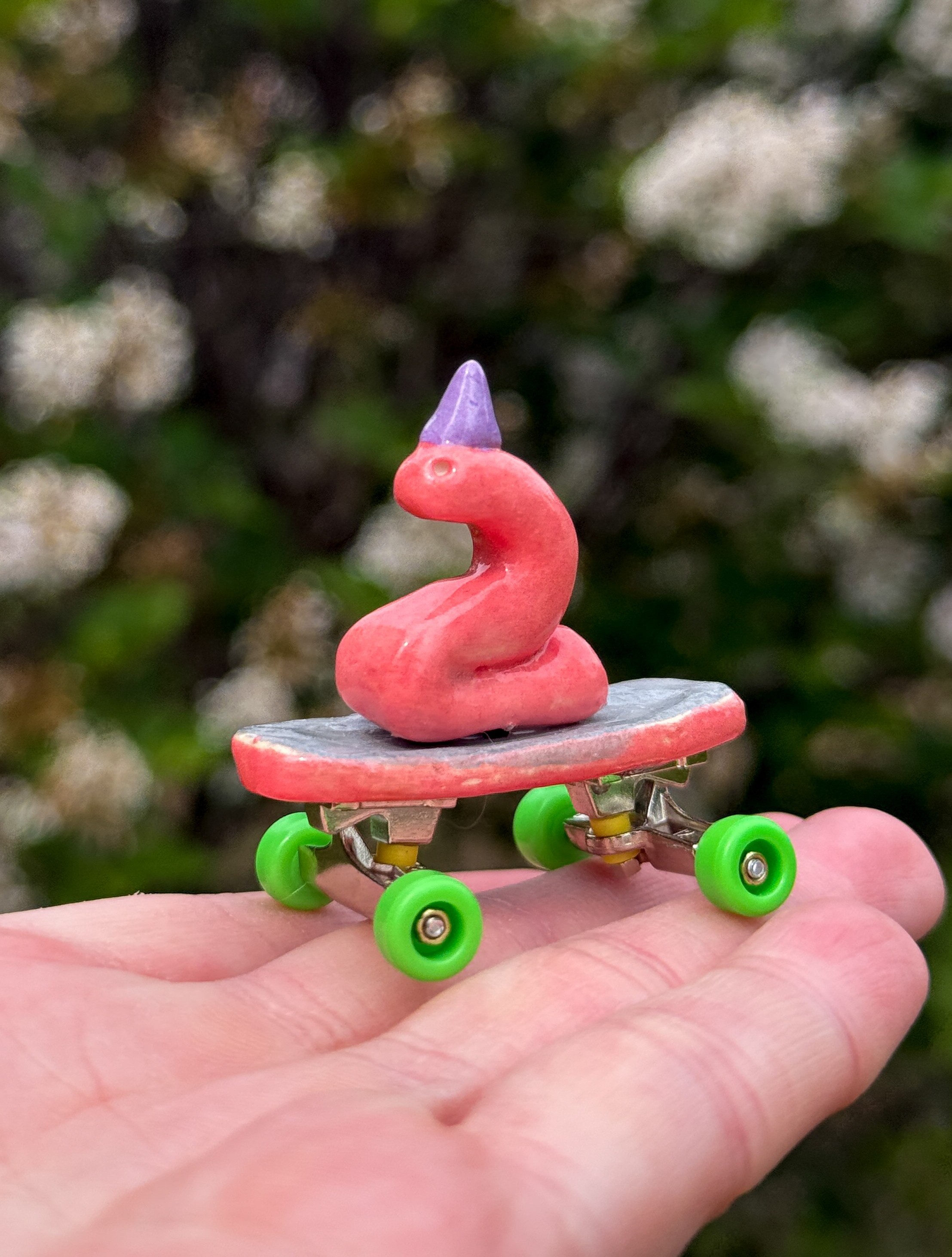 a worm on a skateboard with a hat