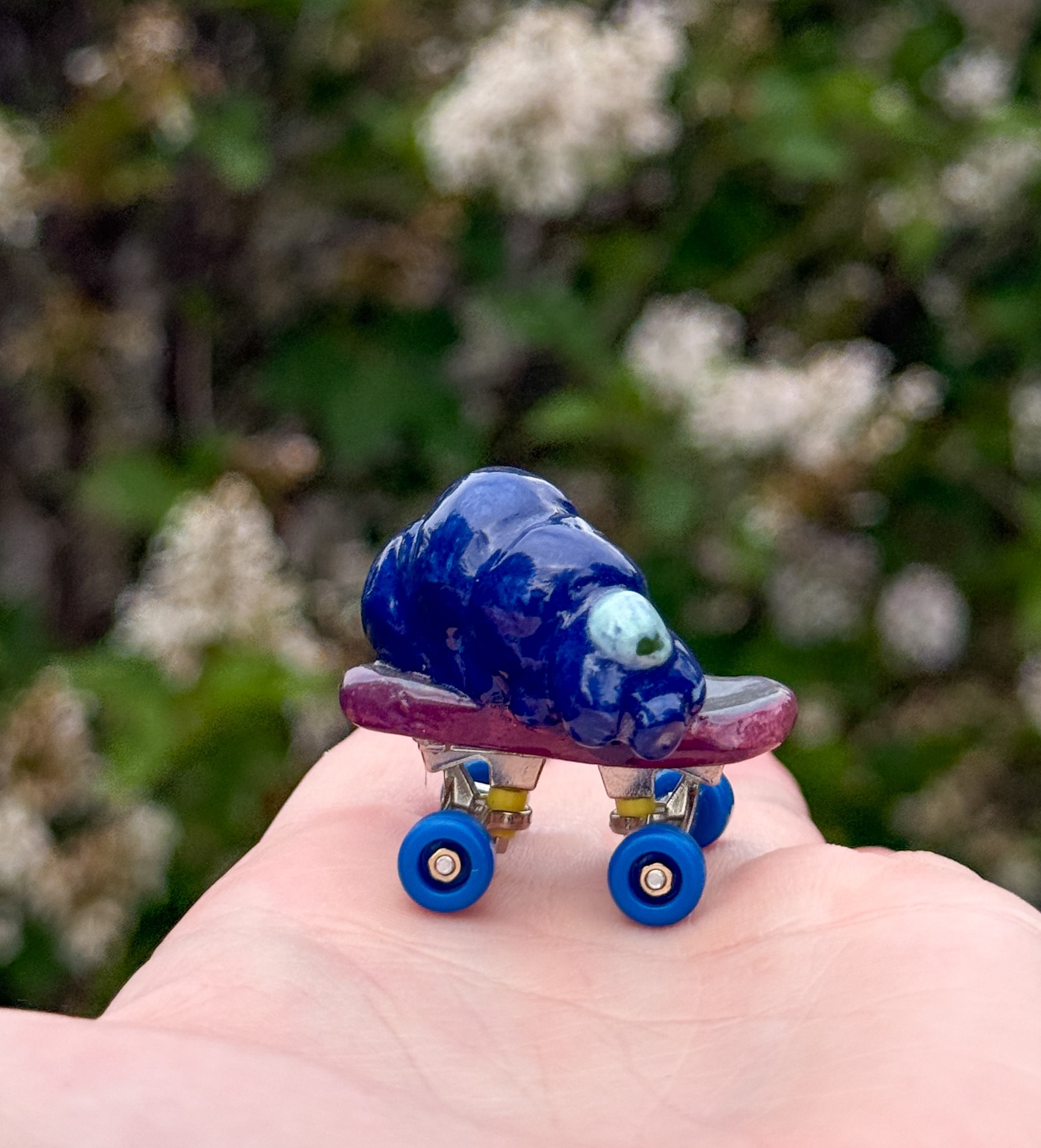 a blue tardigrade on a skateboard